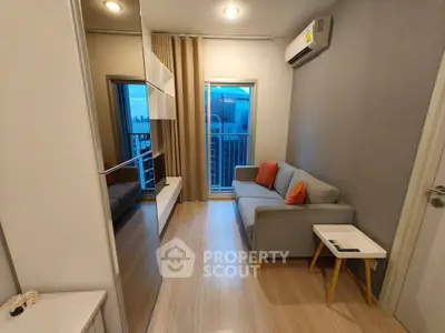 Modern living room with sleek design, cozy sofa, and balcony view in a stylish apartment.