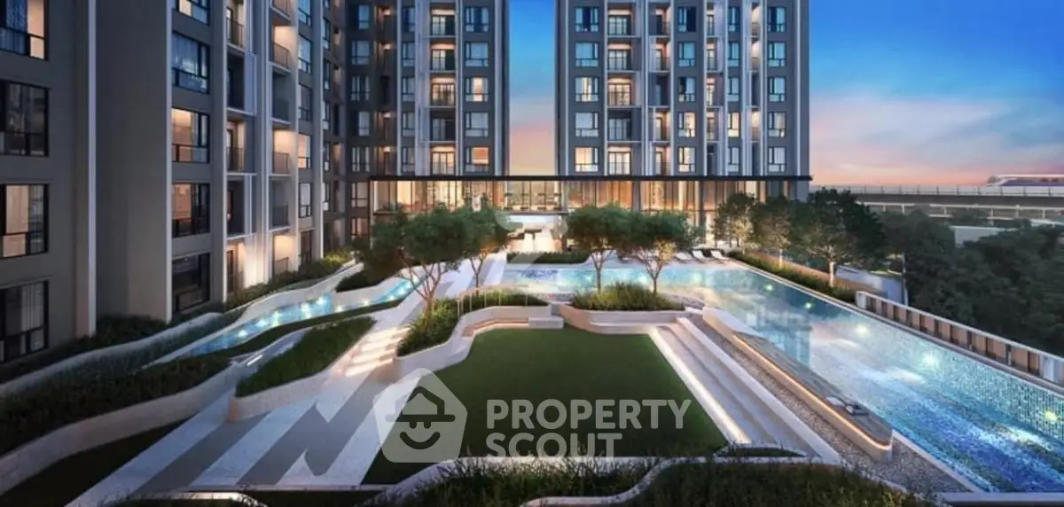 Luxurious modern apartment complex with stunning pool and landscaped garden at sunset.