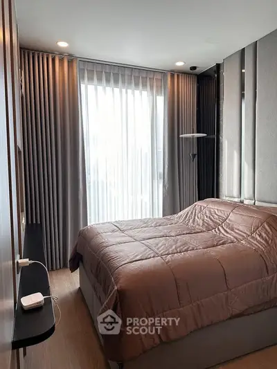 Modern bedroom with stylish decor and large window for natural light