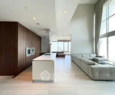 Spacious modern living room with open kitchen and large windows
