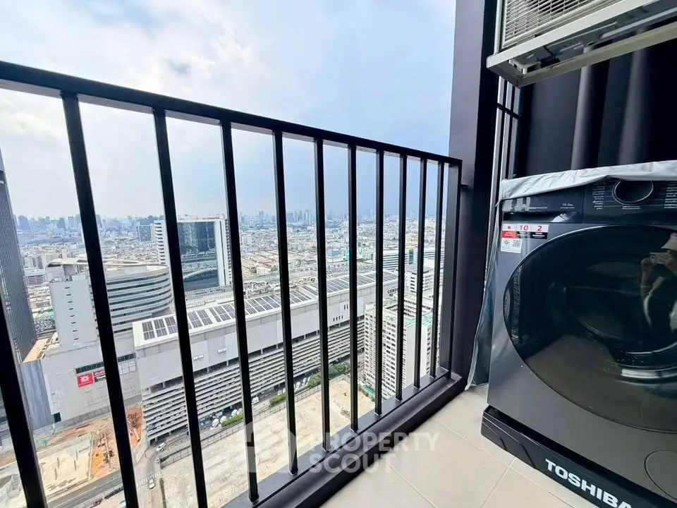 Stunning high-rise balcony view with cityscape and modern washing machine.