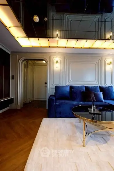 Luxurious living room with elegant blue sofa and stylish ceiling lighting