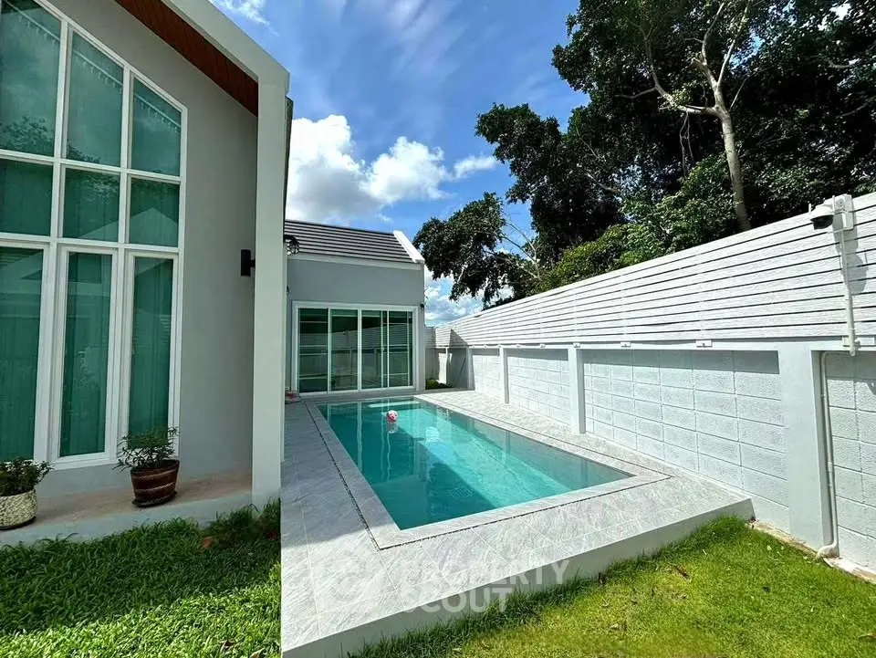 Modern home with private pool and lush garden in serene setting