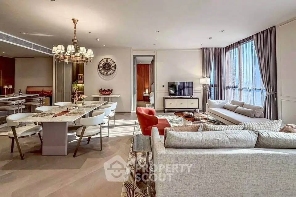 Luxurious open-plan living and dining area with elegant furnishings and natural light.