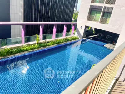 Luxurious rooftop pool with city views in modern apartment complex.