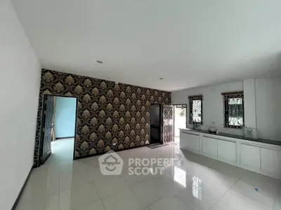 Spacious living room with elegant wallpaper and natural light