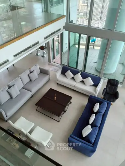 Luxurious modern living room with panoramic city views and stylish furniture.