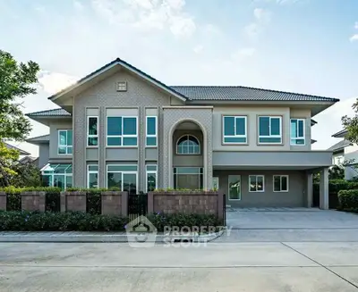 Stunning modern two-story house with large windows and elegant facade