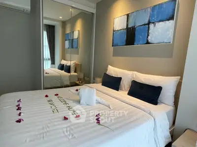 Luxurious bedroom with elegant decor and cozy bedding in modern apartment.