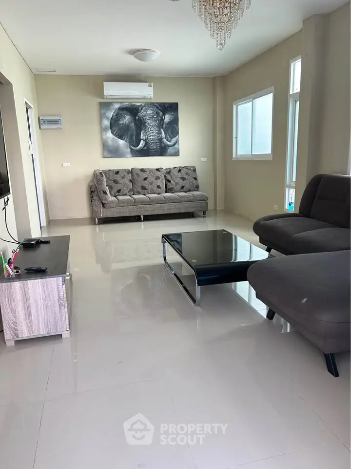 Spacious modern living room with elegant furniture and large windows for natural light.