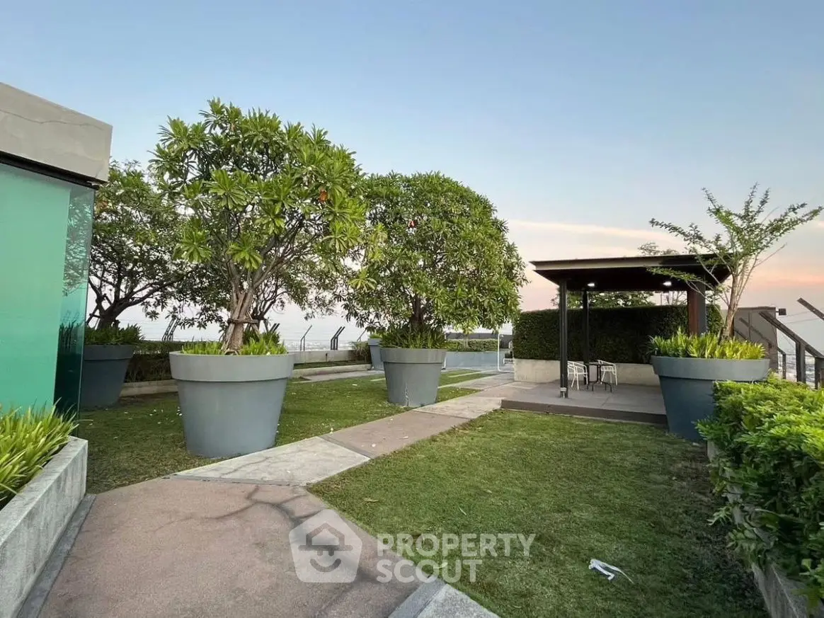 Stunning rooftop garden with lush greenery and seating area, perfect for relaxation and city views.