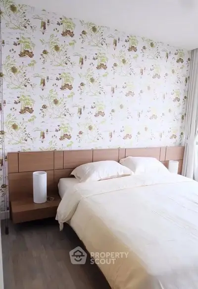 Spacious bedroom with elegant wallpaper and modern wooden headboard, perfect for a cozy retreat.