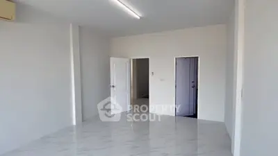 Spacious unfurnished room with white walls and marble flooring, ideal for customization.