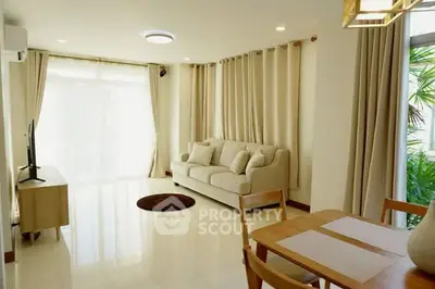 Bright and spacious living room with modern decor and large windows