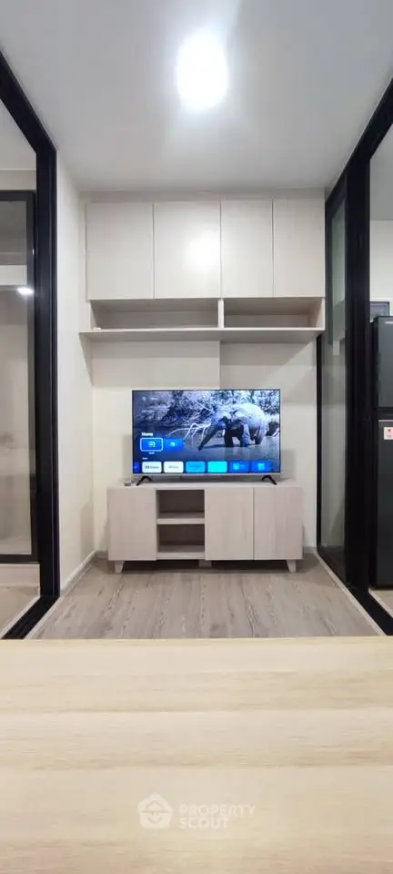 Modern living room with sleek TV setup and stylish cabinetry, perfect for contemporary urban living.