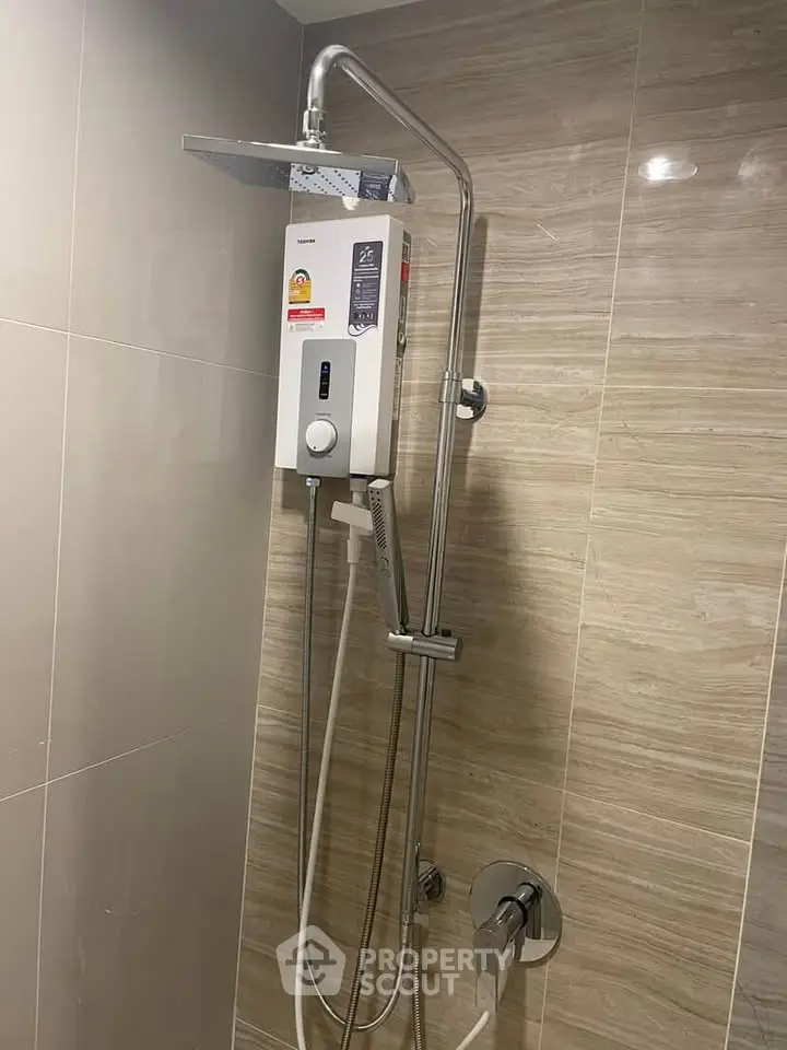Modern bathroom with sleek shower system and elegant tile design.