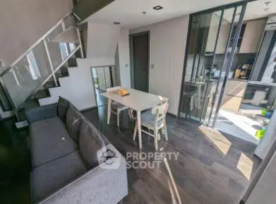 Modern duplex apartment with sleek interior design and open kitchen layout.