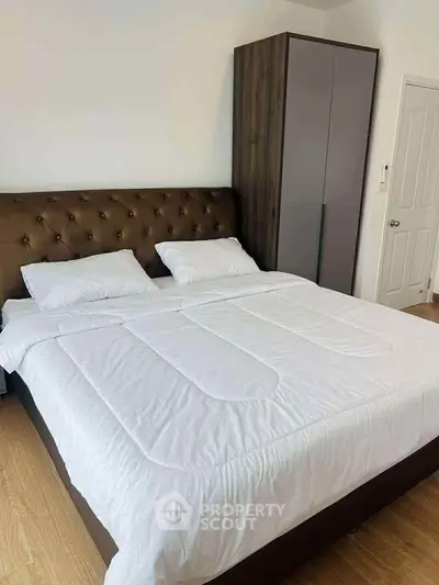 Spacious bedroom with modern furnishings and ample natural light.