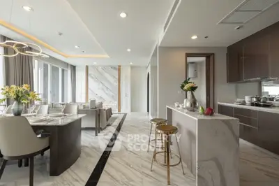 Luxurious open-layout kitchen and dining area with marble flooring and modern decor.