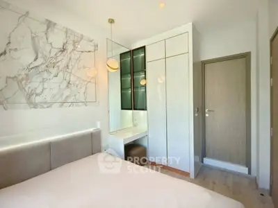 Modern bedroom with elegant marble accent wall and sleek built-in wardrobe