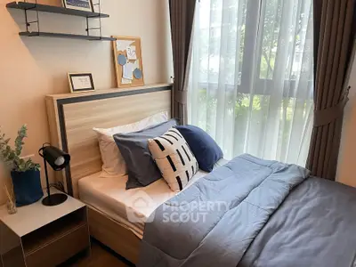 Cozy bedroom with modern decor and large window view