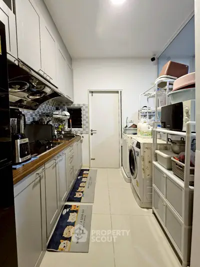 Compact kitchen with modern appliances and efficient storage solutions