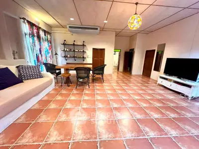 Spacious living room with terracotta tiles and modern decor