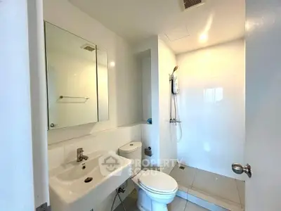 Modern bathroom with sleek fixtures and spacious shower area
