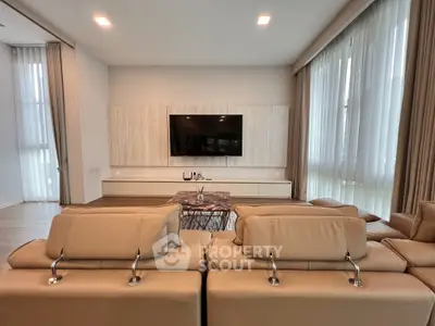 Luxurious modern living room with elegant decor and large windows for natural light.