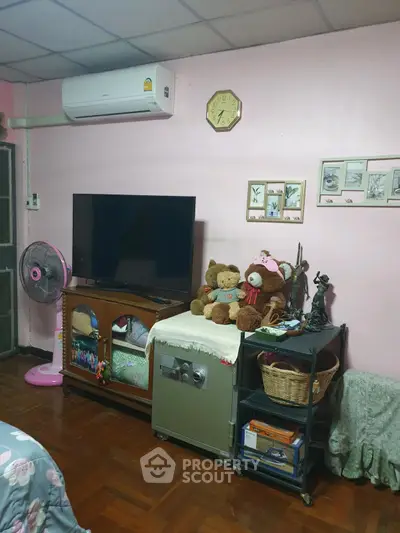 Cozy living room with TV, air conditioning, and charming decor