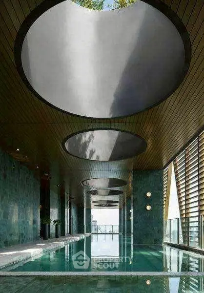 Luxurious indoor pool with modern architectural design and skylights
