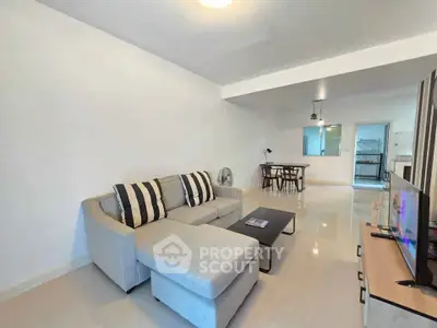 Spacious modern living room with sleek furniture and open layout, perfect for relaxation and entertainment.
