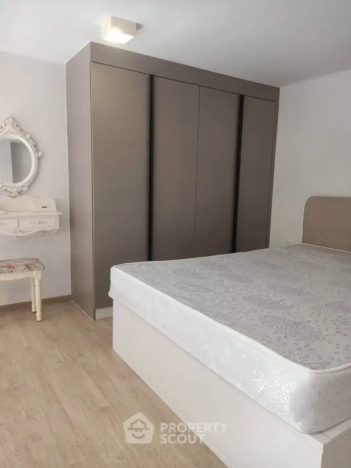 Spacious bedroom with modern wardrobe and elegant decor