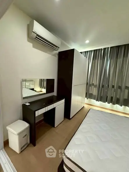 Modern bedroom with air conditioning, wardrobe, and stylish furniture in a cozy apartment.