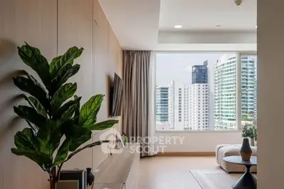 Modern living room with large window offering stunning city view, stylish decor, and abundant natural light.