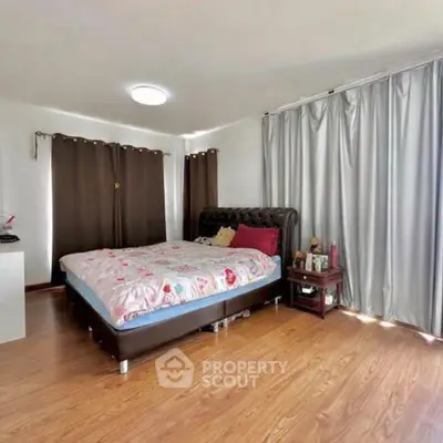 Spacious bedroom with elegant decor and natural light