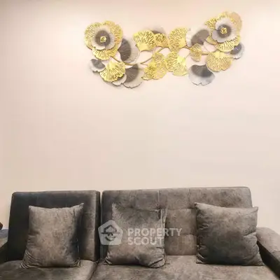 Elegant living room with plush gray sofa and artistic wall decor