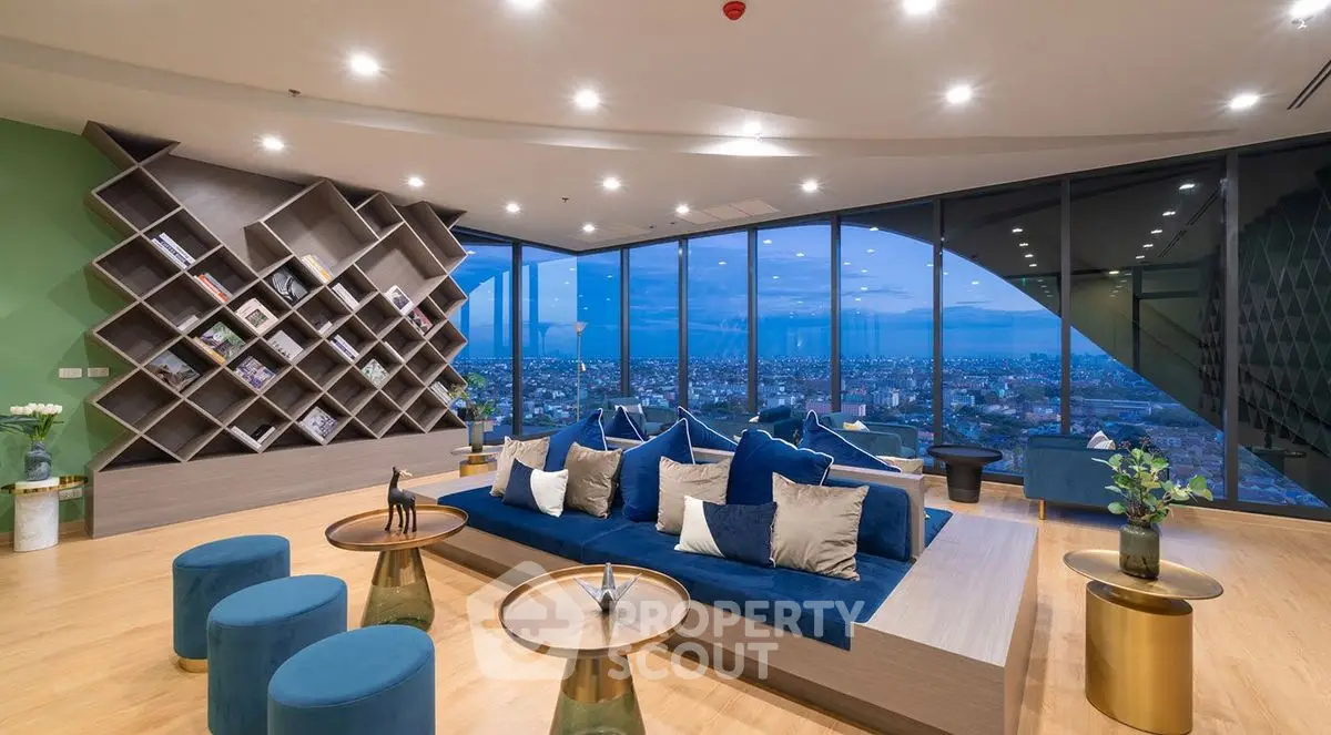 Luxurious modern living room with panoramic city view and stylish blue decor.