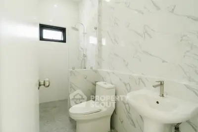 Modern bathroom with marble tiles and sleek fixtures