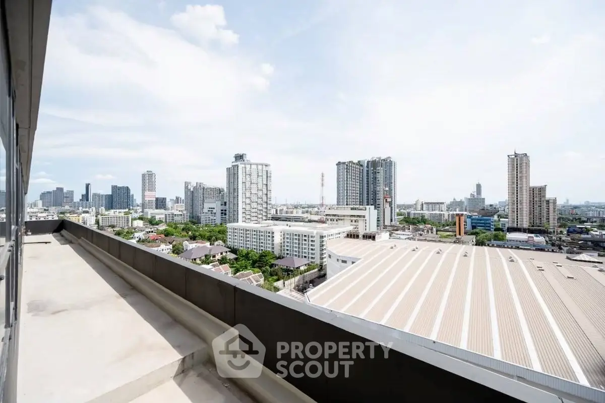 Stunning cityscape view from a high-rise balcony overlooking urban skyline.