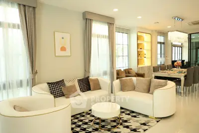 Elegant modern living room with stylish furniture and dining area, perfect for entertaining guests.