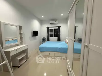 Spacious bedroom with modern furnishings and ample storage in a cozy apartment.