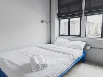 Cozy minimalist bedroom with natural light and modern decor