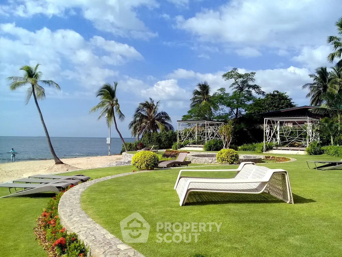 Luxurious beachfront property with lush garden and stunning ocean view, perfect for relaxation and leisure.