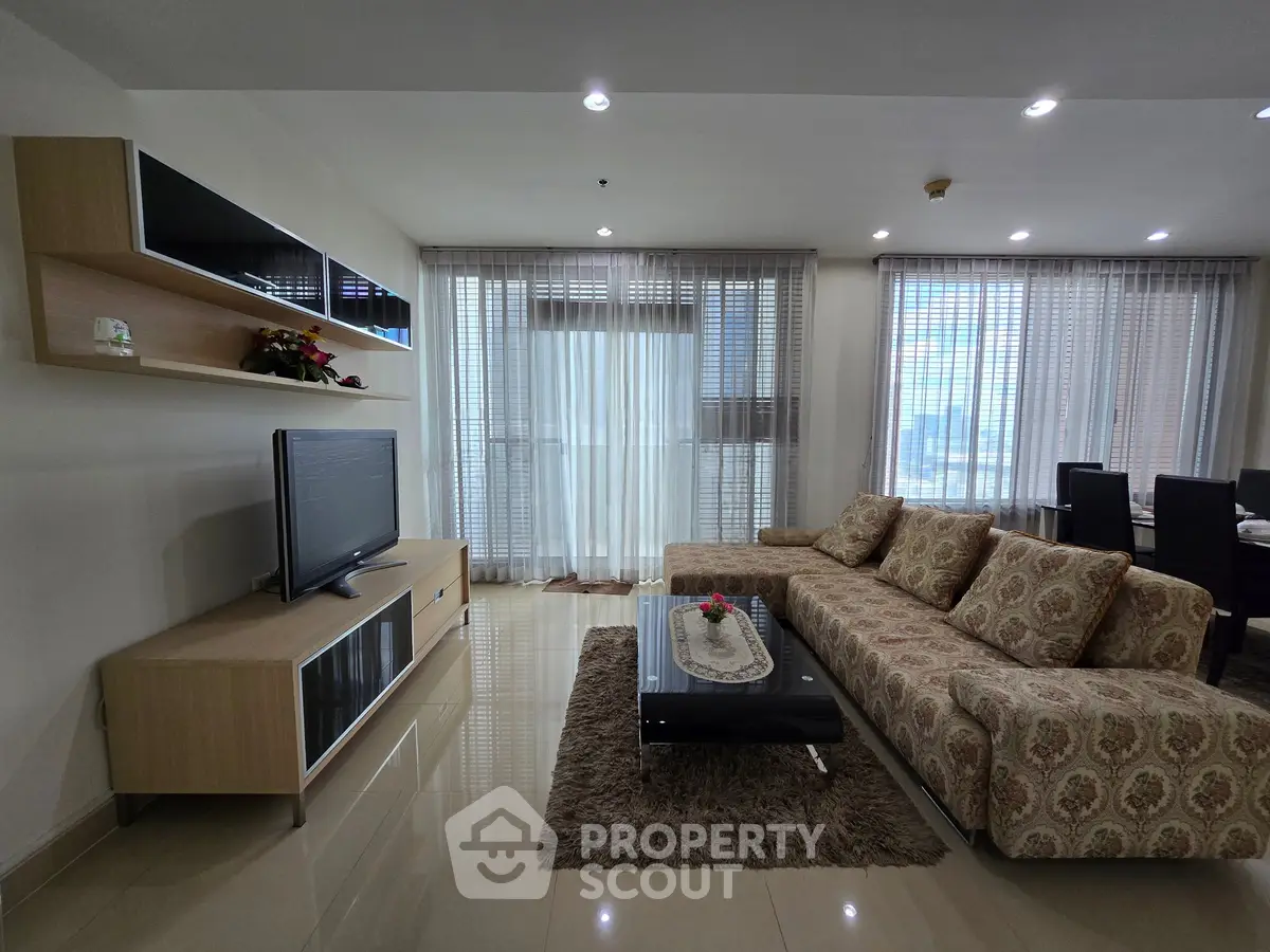 Spacious living room with modern decor and large windows offering ample natural light.