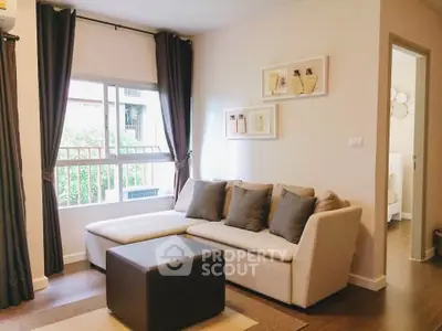 Cozy living room with modern sofa and natural light, perfect for relaxation.