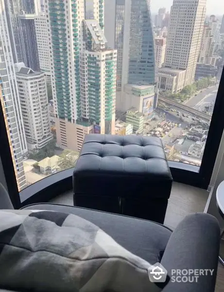 High-rise luxury living room with panoramic city views through floor-to-ceiling windows, modern furnishings, and a plush feel.