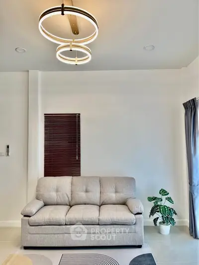 Modern living room with stylish sofa and elegant lighting, perfect for contemporary living.