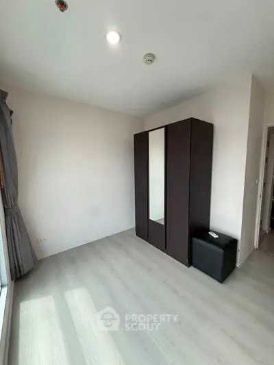 Spacious bedroom with large wardrobe and natural light