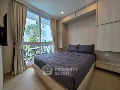 Modern bedroom with large window and elegant decor in a stylish apartment.